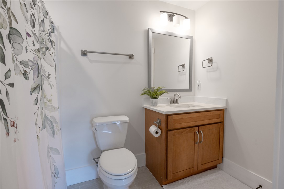 113 South Oak Pointe Drive Seneca, SC 29672 - Photo 30 of 50 This clean and bright bathroom features a modern vanity, a toilet, and a sleek mirror.