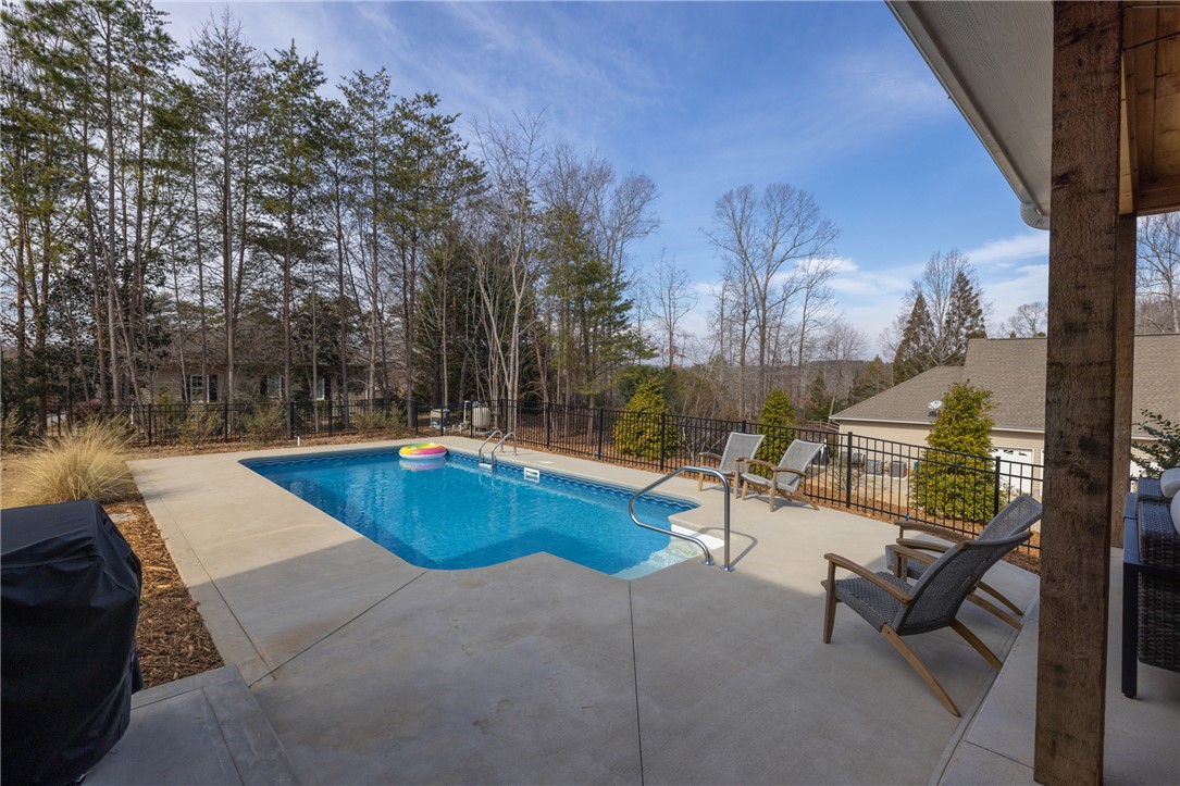 113 South Oak Pointe Drive Seneca, SC 29672 - Photo 34 of 50 Enjoy outdoor living with a spacious pool and surrounding natural beauty.