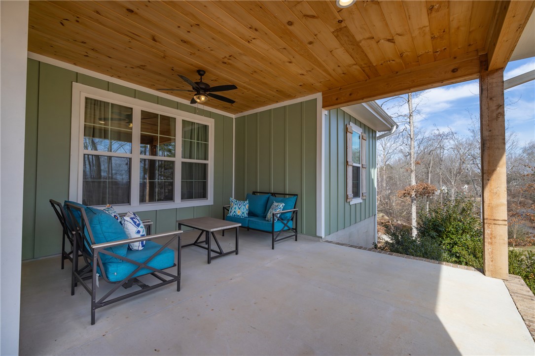 113 South Oak Pointe Drive Seneca, SC 29672 - Photo 4 of 50 Relax on this inviting patio, offering a serene outdoor retreat with a picturesque view.