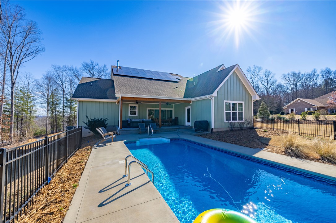 113 South Oak Pointe Drive Seneca, SC 29672 - Photo 5 of 50 This tranquil outdoor oasis features a refreshing pool, ample patio space, and solar panels for sustainable living.