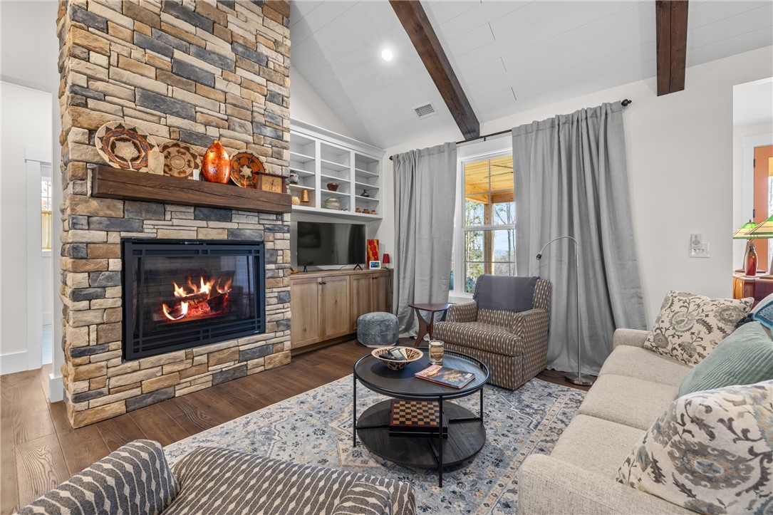 113 South Oak Pointe Drive Seneca, SC 29672 - Photo 8 of 50 Warm and inviting living space with a stone fireplace, perfect for cozy gatherings.