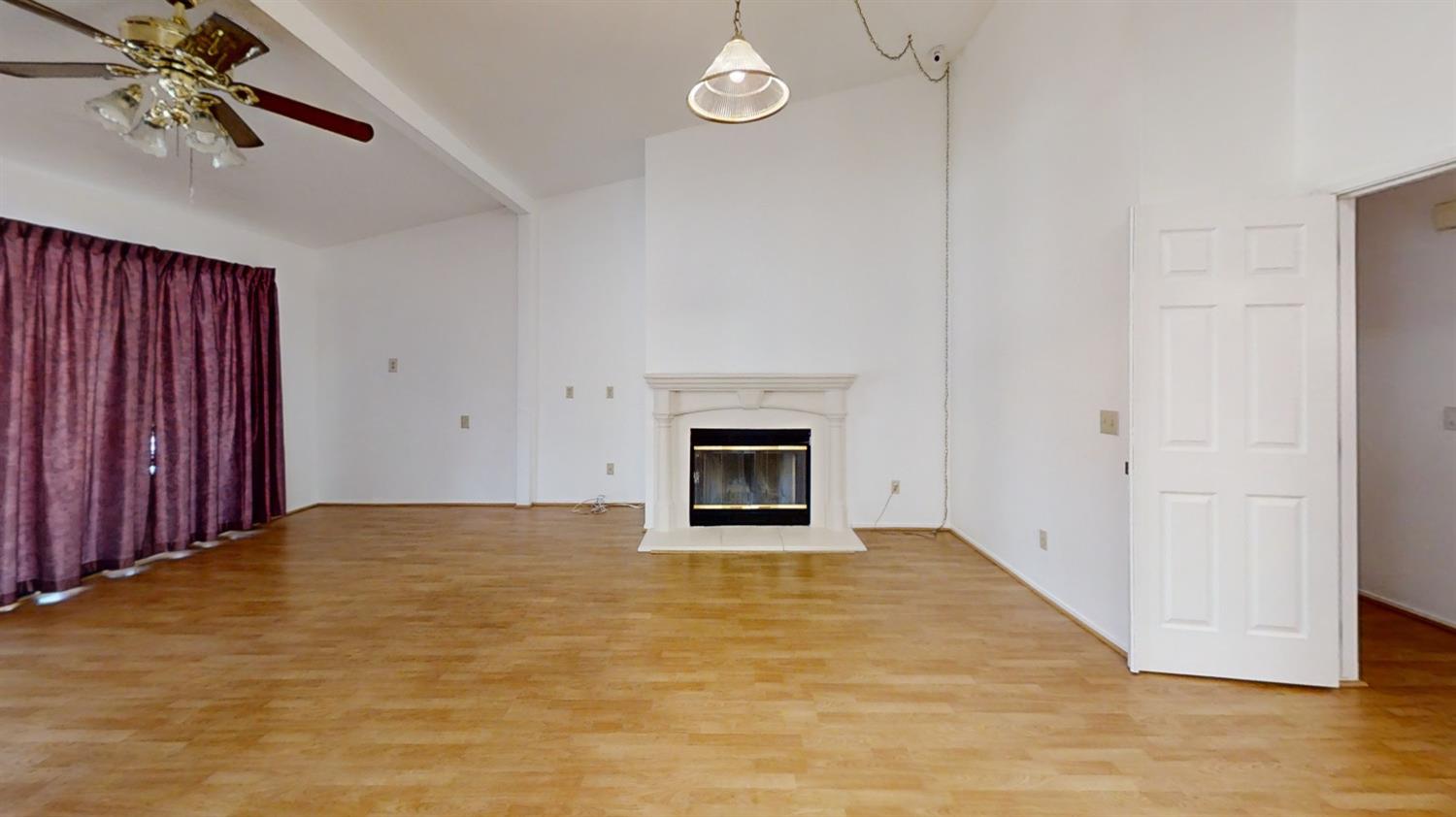 1712 Poppy Meadow Court Coalinga, CA 93210 - Photo 14 of 30 a view of an empty room with a fireplace and a window