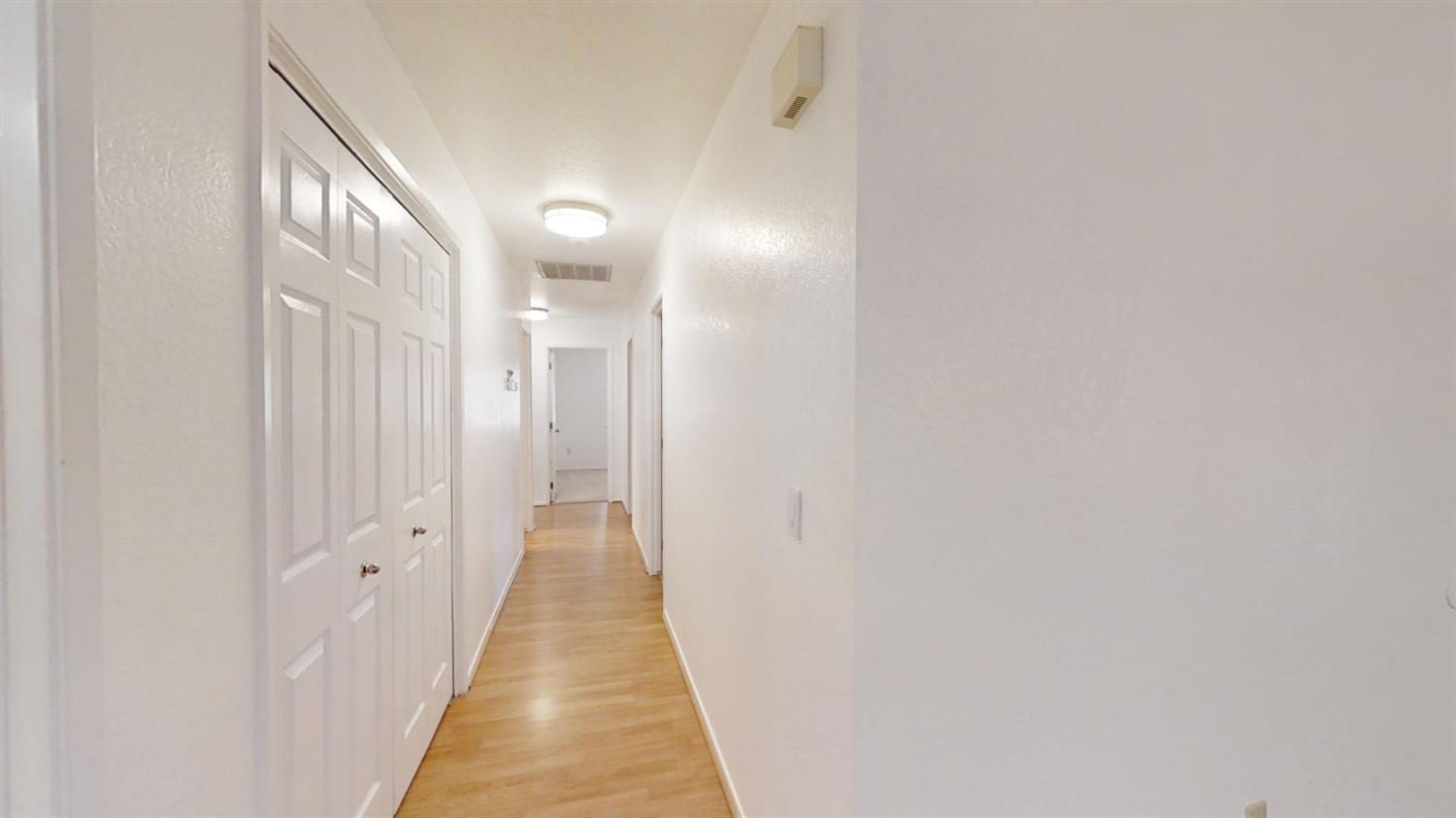 1712 Poppy Meadow Court Coalinga, CA 93210 - Photo 15 of 30 a view of a hallway with wooden floor