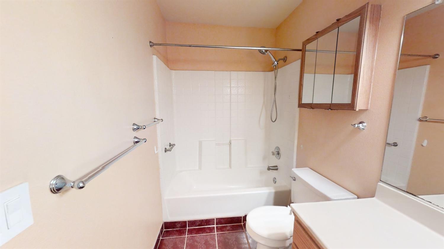 1712 Poppy Meadow Court Coalinga, CA 93210 - Photo 18 of 30 a bathroom with a bathtub and shower
