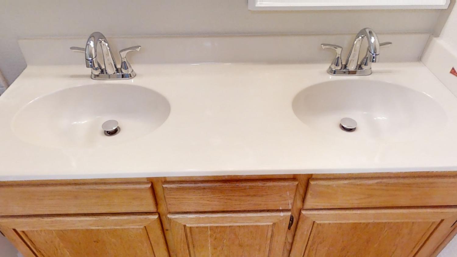 1712 Poppy Meadow Court Coalinga, CA 93210 - Photo 27 of 30 a bathroom with a sink and a mirror