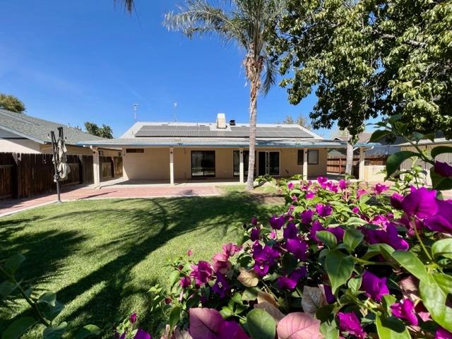 1712 Poppy Meadow Court Coalinga, CA 93210 - Photo 30 of 30 a front view of a house with a big yard and potted plants