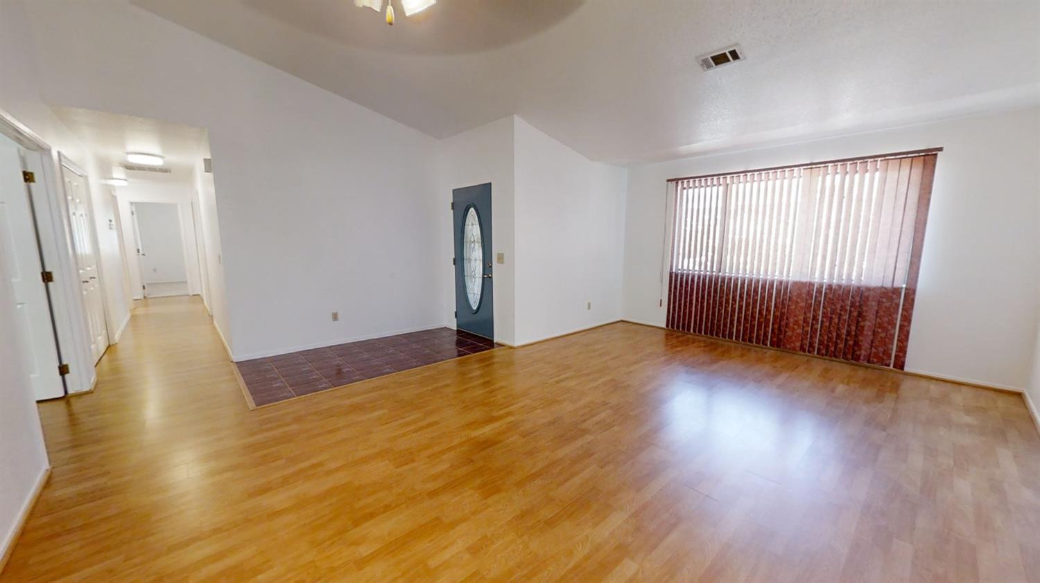 1712 Poppy Meadow Court Coalinga, CA 93210 - Photo 3 of 30 an empty room with wooden floor and windows