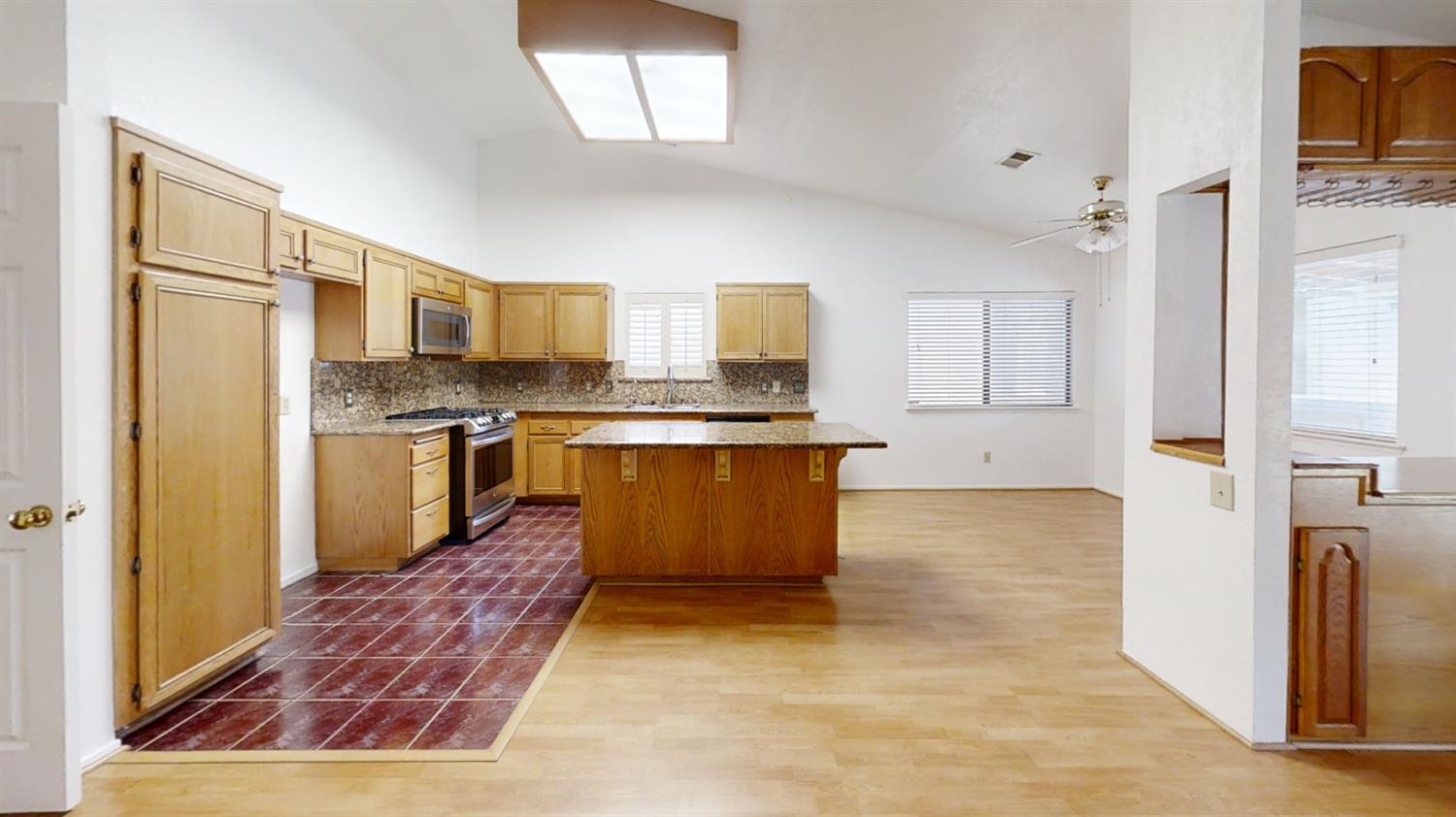 1712 Poppy Meadow Court Coalinga, CA 93210 - Photo 7 of 30 a large kitchen with stainless steel appliances granite countertop a stove top oven a refrigerator and a cabinets