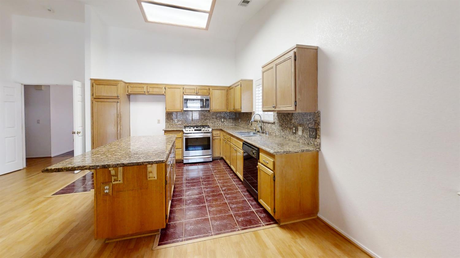 1712 Poppy Meadow Court Coalinga, CA 93210 - Photo 8 of 30 a kitchen with stainless steel appliances granite countertop a sink a stove top oven a counter space and cabinets