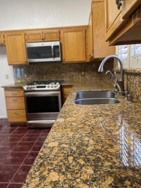 1712 Poppy Meadow Court Coalinga, CA 93210 - Photo 9 of 30 a kitchen with granite countertop a stove and a sink