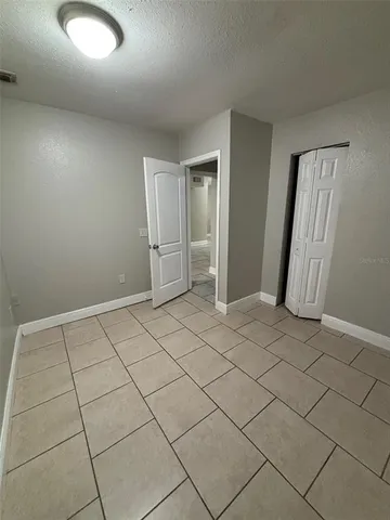 a view of a electric appliances in kitchen and an empty room