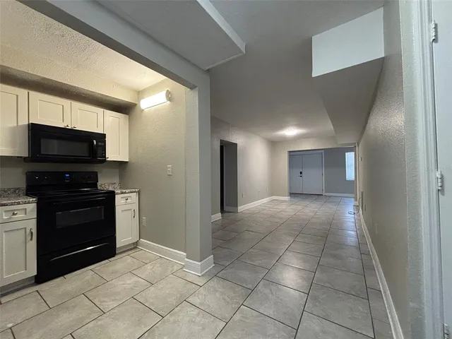 a kitchen with a refrigerator and a stove
