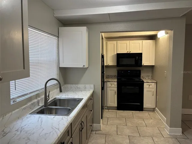 a kitchen with a cabinets and window