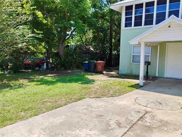 a view of a house with a yard and sitting area