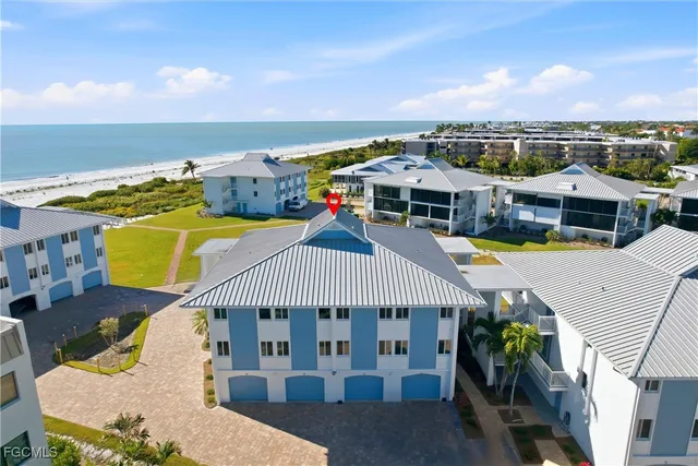 an aerial view of a house with swimming pool outdoor seating