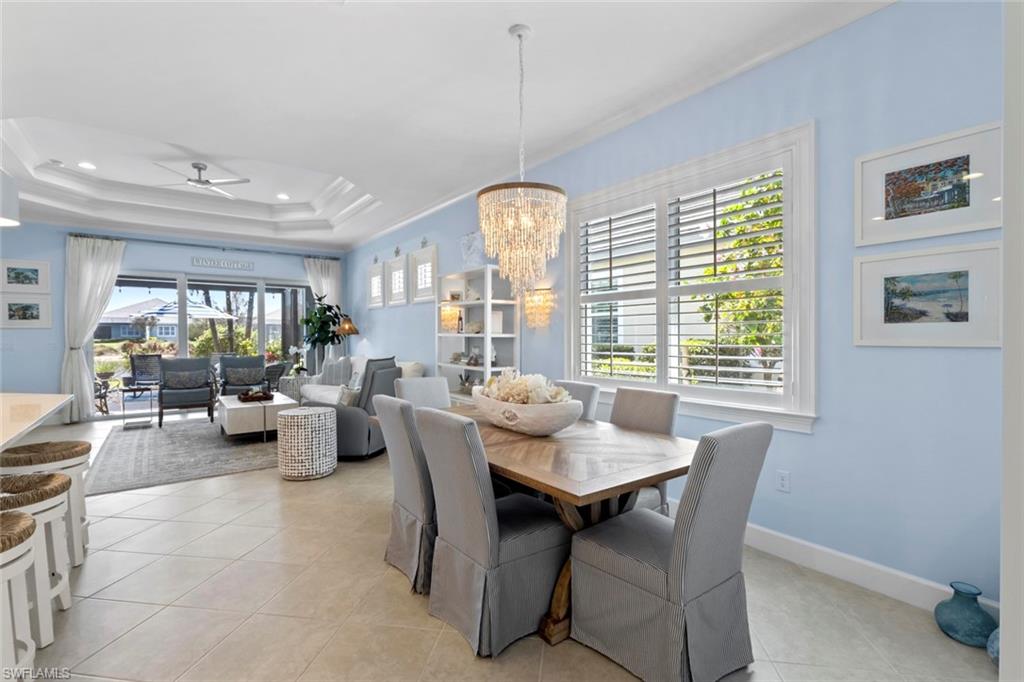 5690 Elbow Avenue Naples, FL 34113 - Photo 12 of 39 a dining room with furniture a chandelier and window