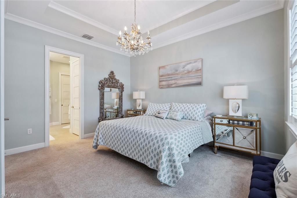 5690 Elbow Avenue Naples, FL 34113 - Photo 13 of 39 a bedroom with a bed chandelier and a window
