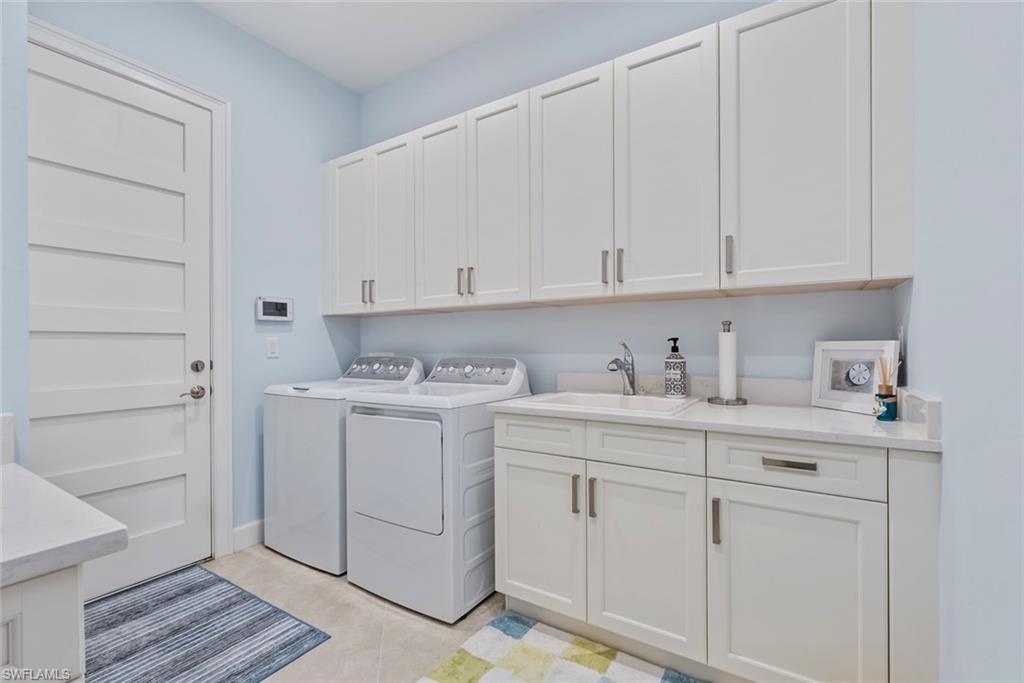 5690 Elbow Avenue Naples, FL 34113 - Photo 18 of 39 a view of cabinets with white cabinets