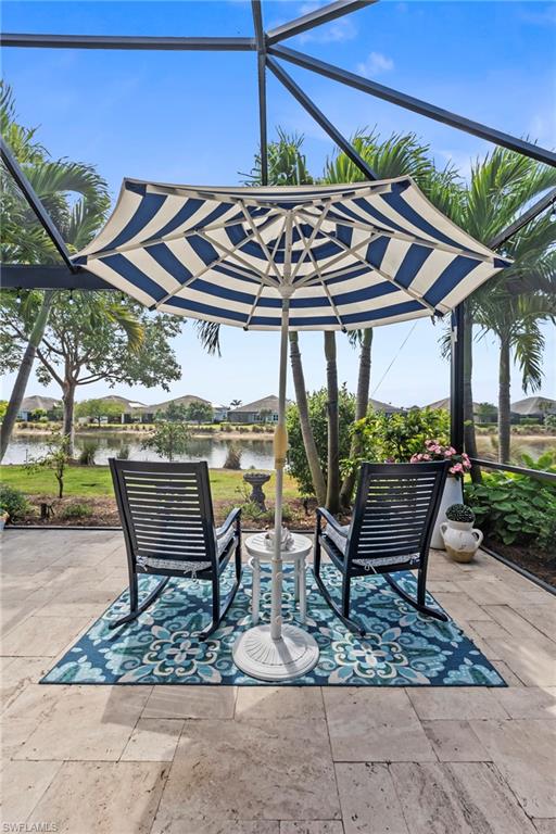 5690 Elbow Avenue Naples, FL 34113 - Photo 23 of 39 a view of a table and chairs under an umbrella