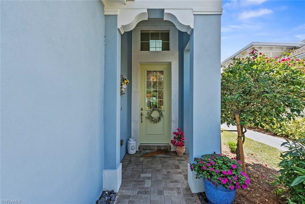 5690 Elbow Avenue Naples, FL 34113 - Photo 24 of 39 a front view of a house with a yard