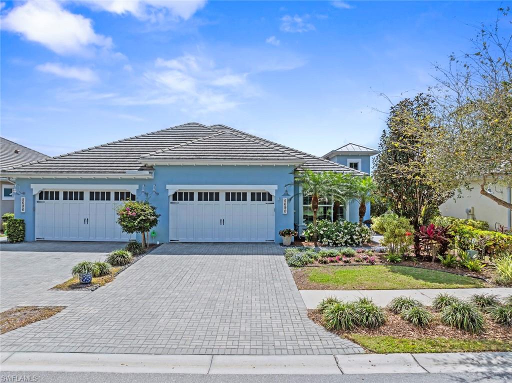 5690 Elbow Avenue Naples, FL 34113 - Photo 25 of 39 front view of a house with a garden