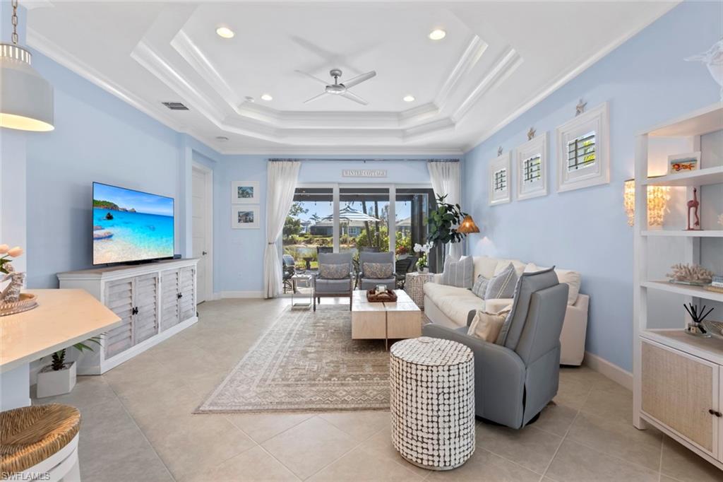 5690 Elbow Avenue Naples, FL 34113 - Photo 5 of 39 a living room with furniture and a flat screen tv