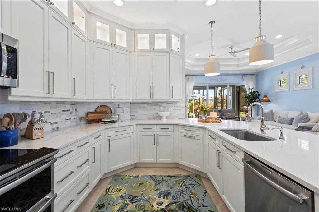 5690 Elbow Avenue Naples, FL 34113 - Photo 8 of 39 a kitchen with a sink window and cabinets