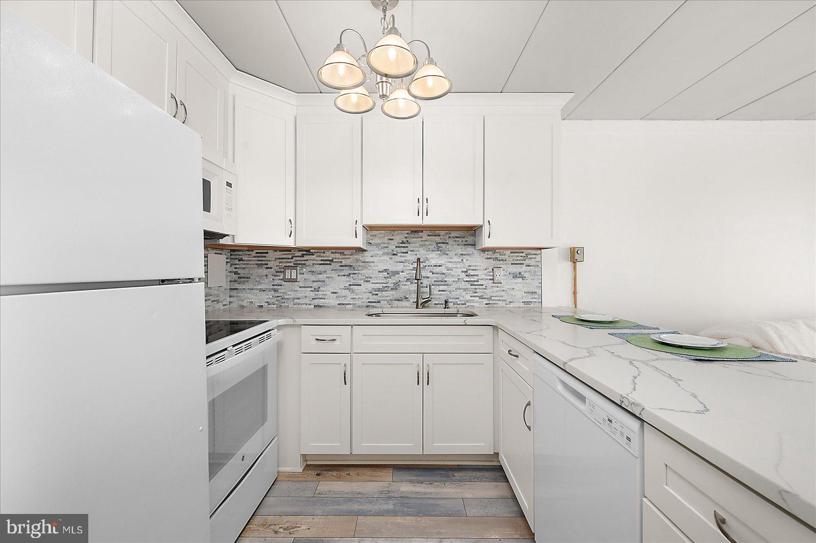 18 69th Street, Unit 9 Ocean City, MD 21842 - Photo 14 of 60 a kitchen with cabinets appliances and a counter top