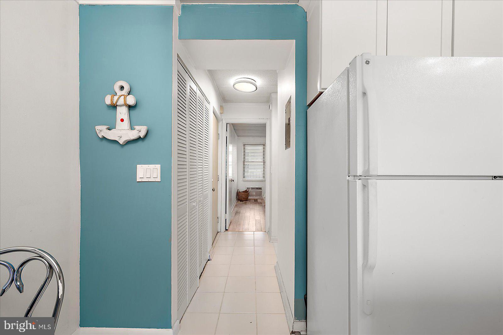 18 69th Street, Unit 9 Ocean City, MD 21842 - Photo 22 of 60 a view of a hallway with wooden shelves