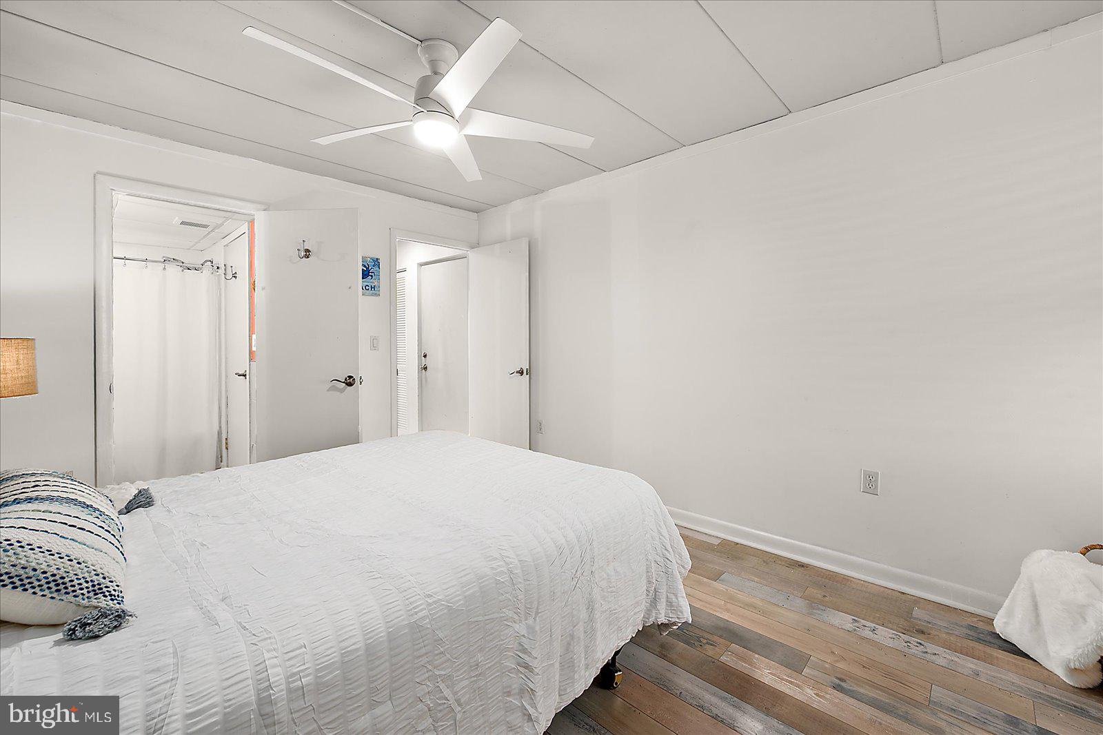 18 69th Street, Unit 9 Ocean City, MD 21842 - Photo 25 of 60 a bedroom with a bed and a ceiling fan