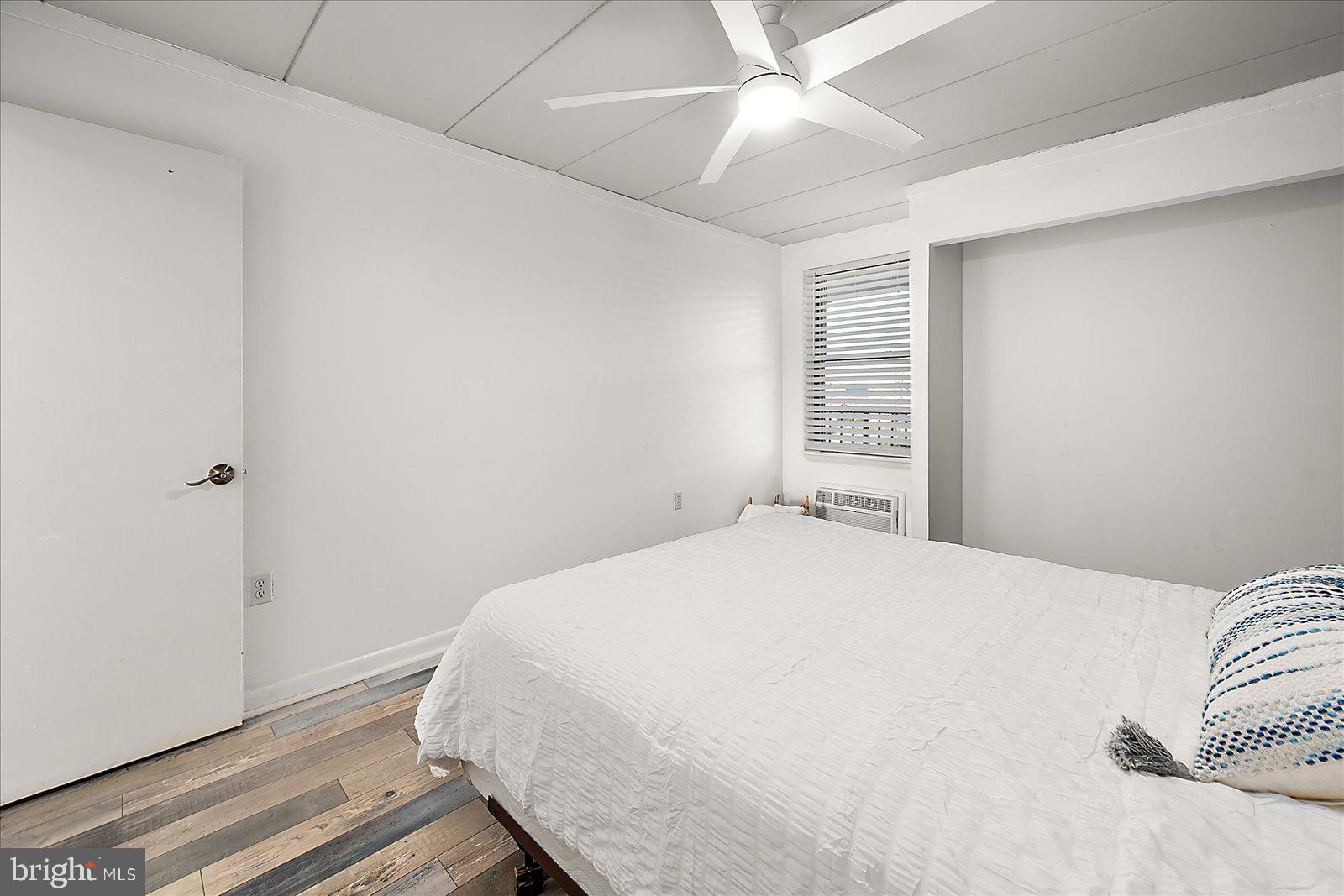 18 69th Street, Unit 9 Ocean City, MD 21842 - Photo 26 of 60 a bedroom with a bed and a window