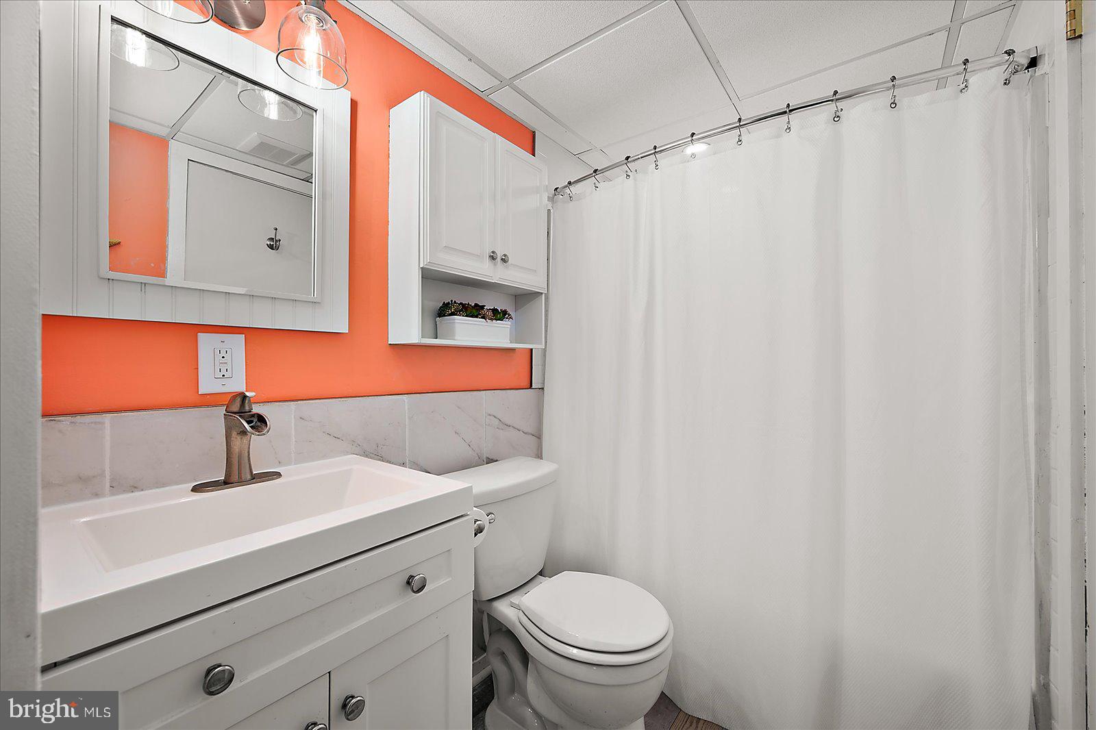 18 69th Street, Unit 9 Ocean City, MD 21842 - Photo 28 of 60 a bathroom with a sink toilet and shower