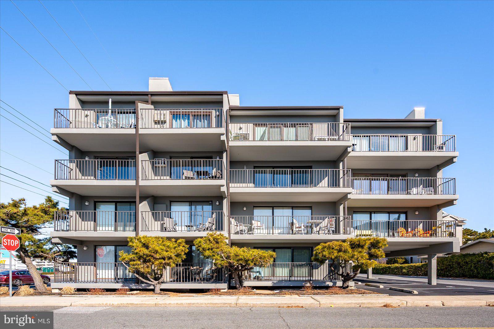18 69th Street, Unit 9 Ocean City, MD 21842 - Photo 43 of 60 a front view of large building with cars parked