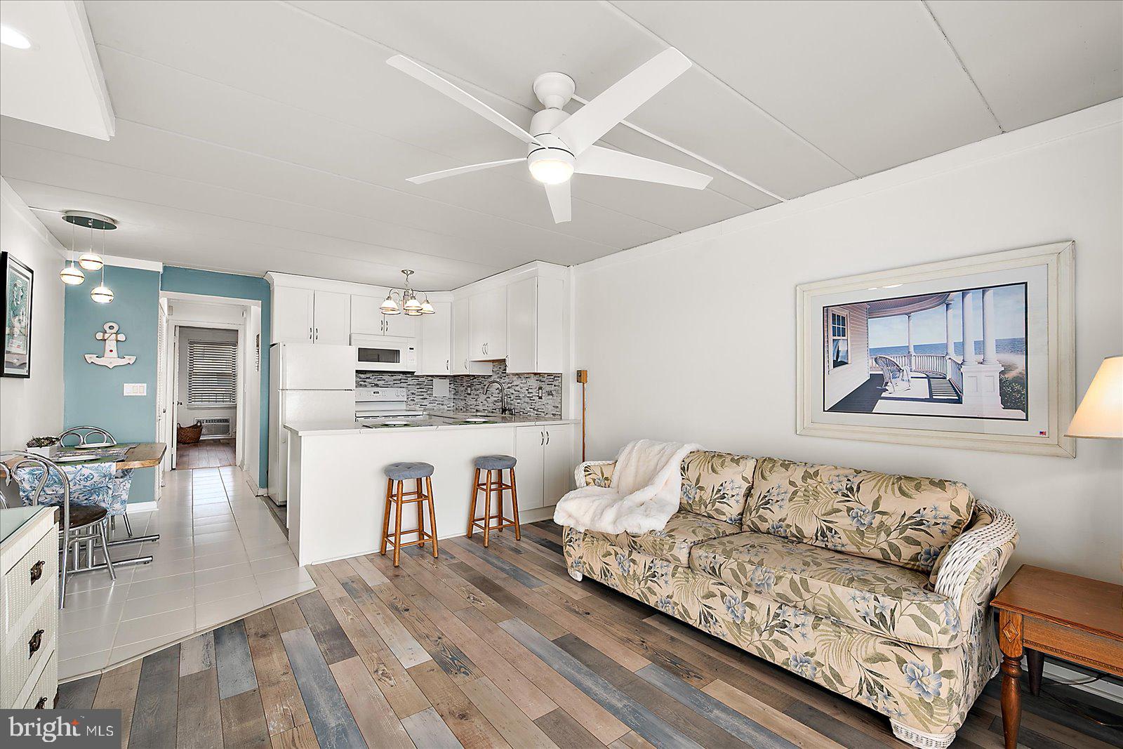 18 69th Street, Unit 9 Ocean City, MD 21842 - Photo 6 of 60 a living room with furniture and a wooden floor