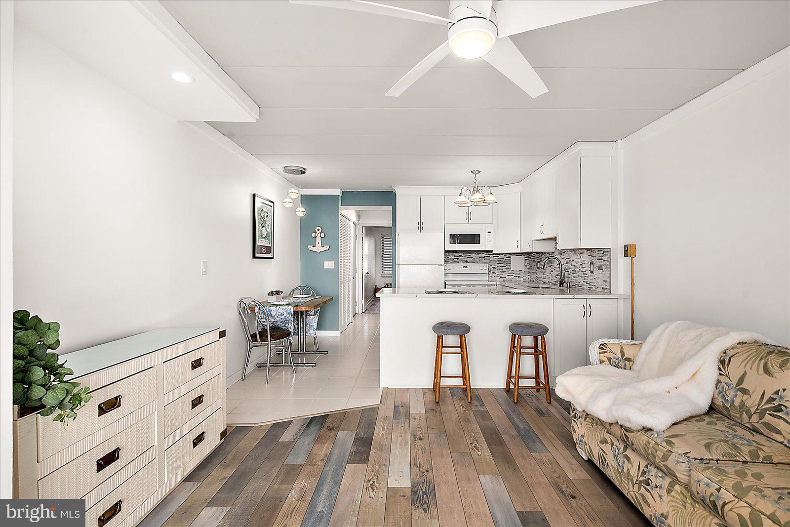 18 69th Street, Unit 9 Ocean City, MD 21842 - Photo 7 of 60 a living room with furniture and a fireplace