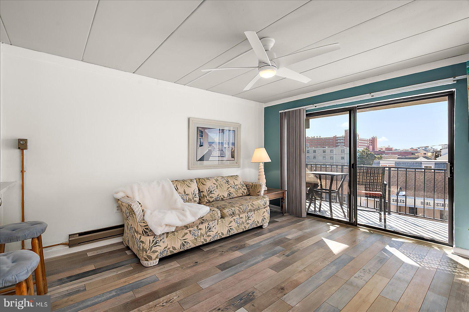 18 69th Street, Unit 9 Ocean City, MD 21842 - Photo 10 of 60 a living room with furniture and a floor to ceiling window