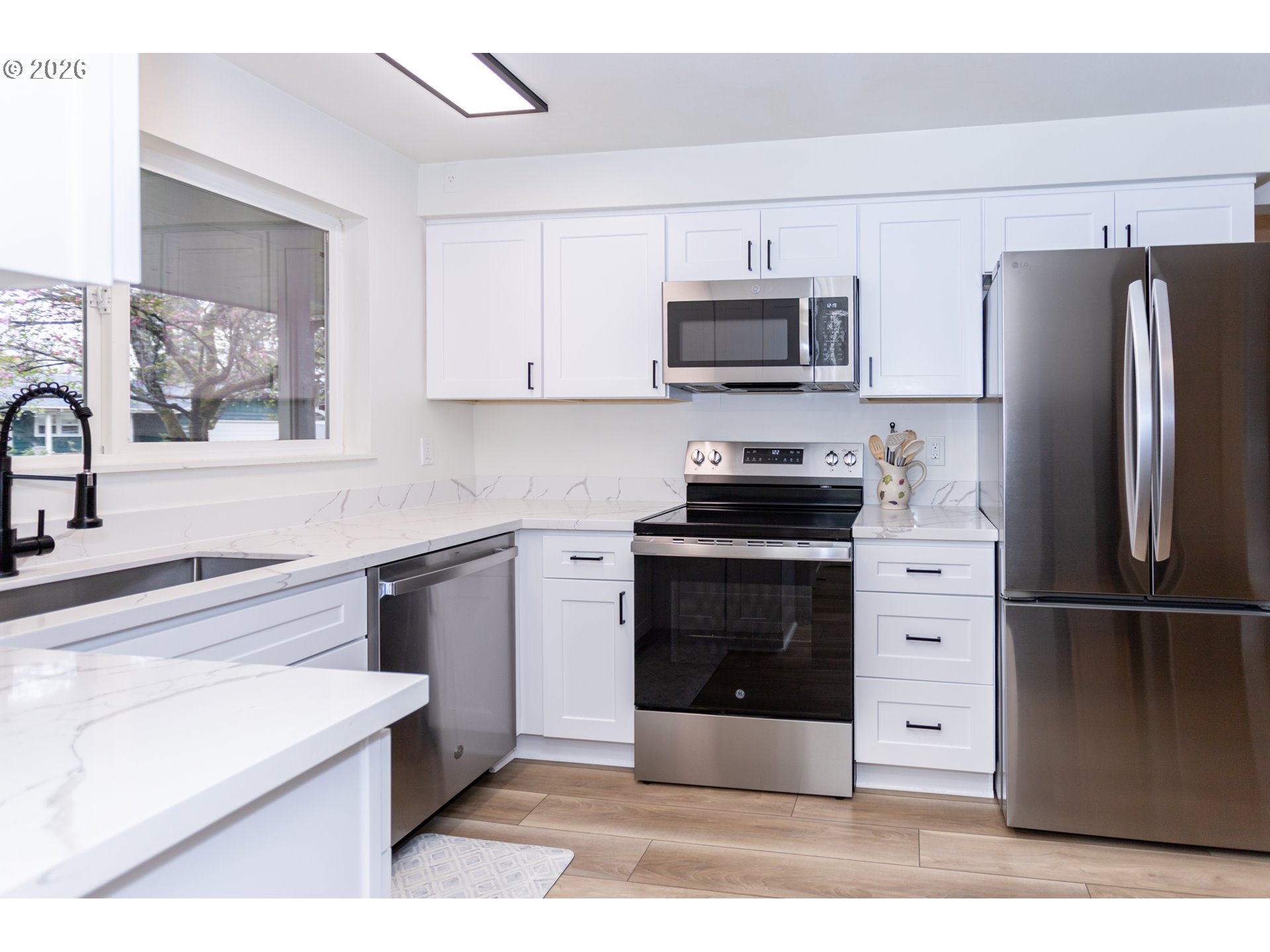 675 Hughes Street Eugene, OR 97402 - Photo 13 of 40 a kitchen with stainless steel appliances a refrigerator stove and microwave
