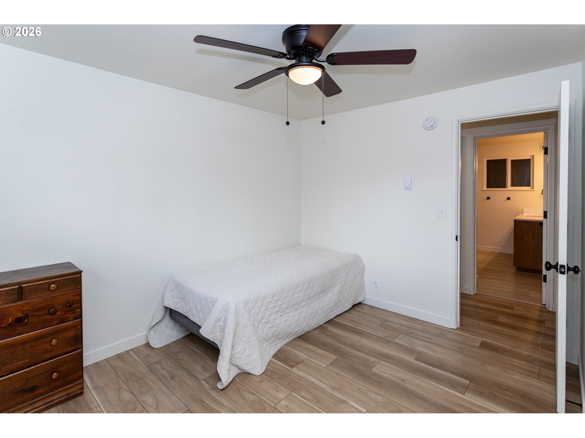 675 Hughes Street Eugene, OR 97402 - Photo 16 of 40 a bedroom with a bed and a ceiling fan