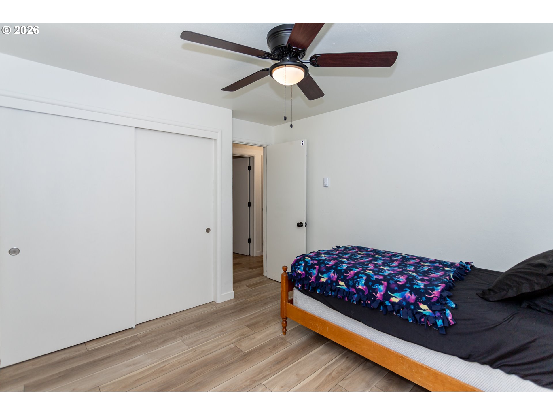 675 Hughes Street Eugene, OR 97402 - Photo 20 of 40 a bed room with a bed and a ceiling fan