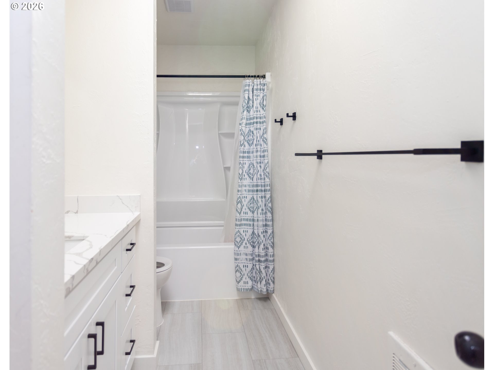 675 Hughes Street Eugene, OR 97402 - Photo 28 of 40 a bathroom with a shower curtain and a sink