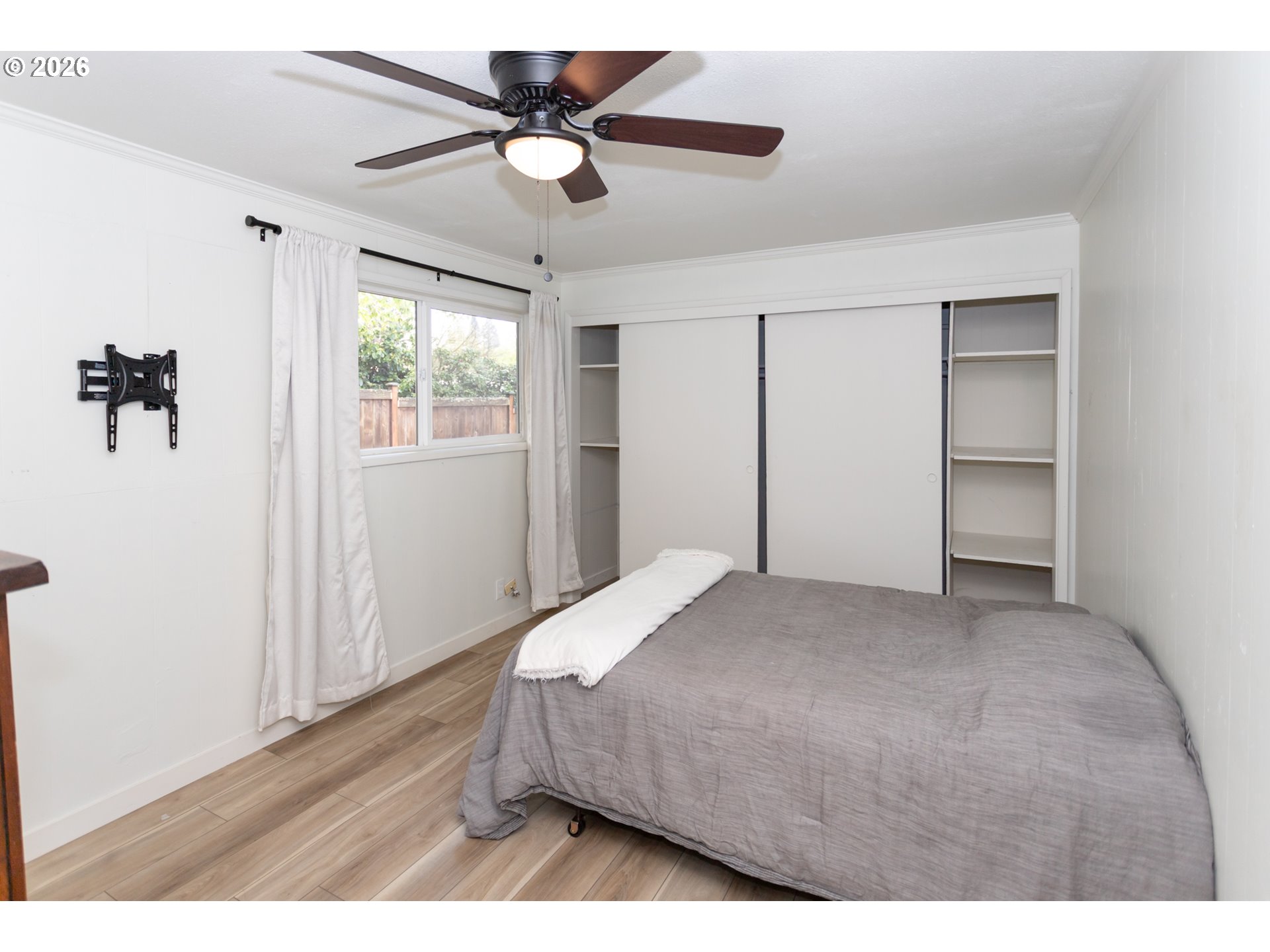 675 Hughes Street Eugene, OR 97402 - Photo 31 of 40 a bedroom with a bed and a chandelier