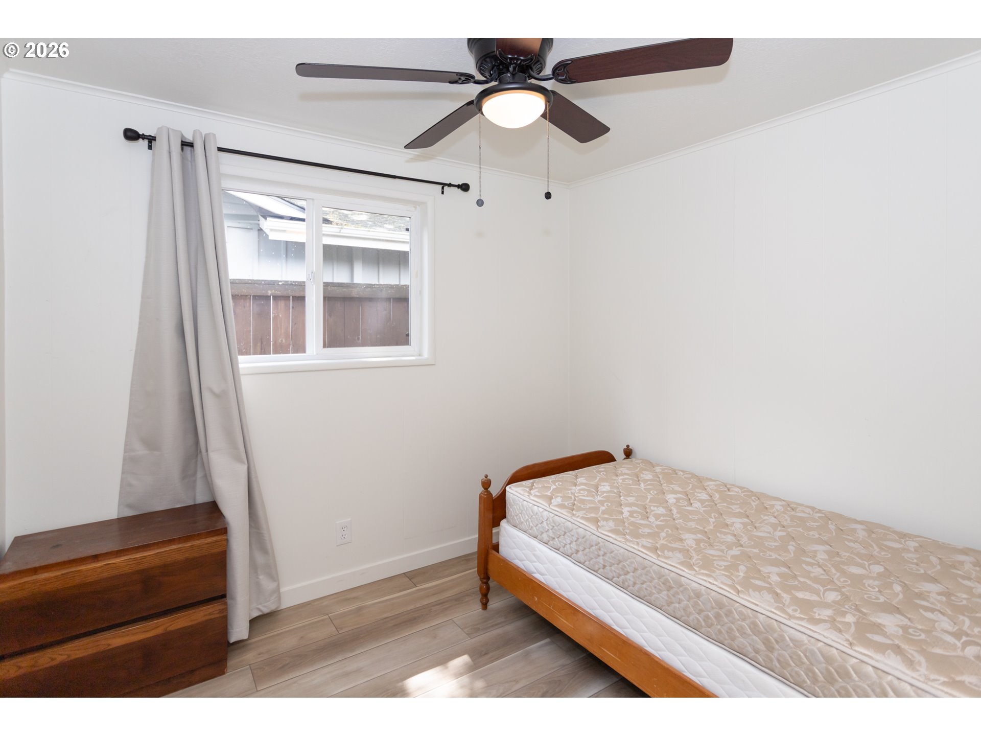 675 Hughes Street Eugene, OR 97402 - Photo 33 of 40 a bedroom with a bed and a chandelier fan