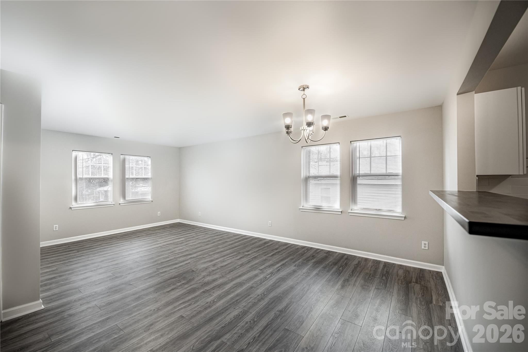 837 Rodey Avenue, Unit 20 Charlotte, NC 28206 - Photo 2 of 12 an empty room with wooden floor and windows