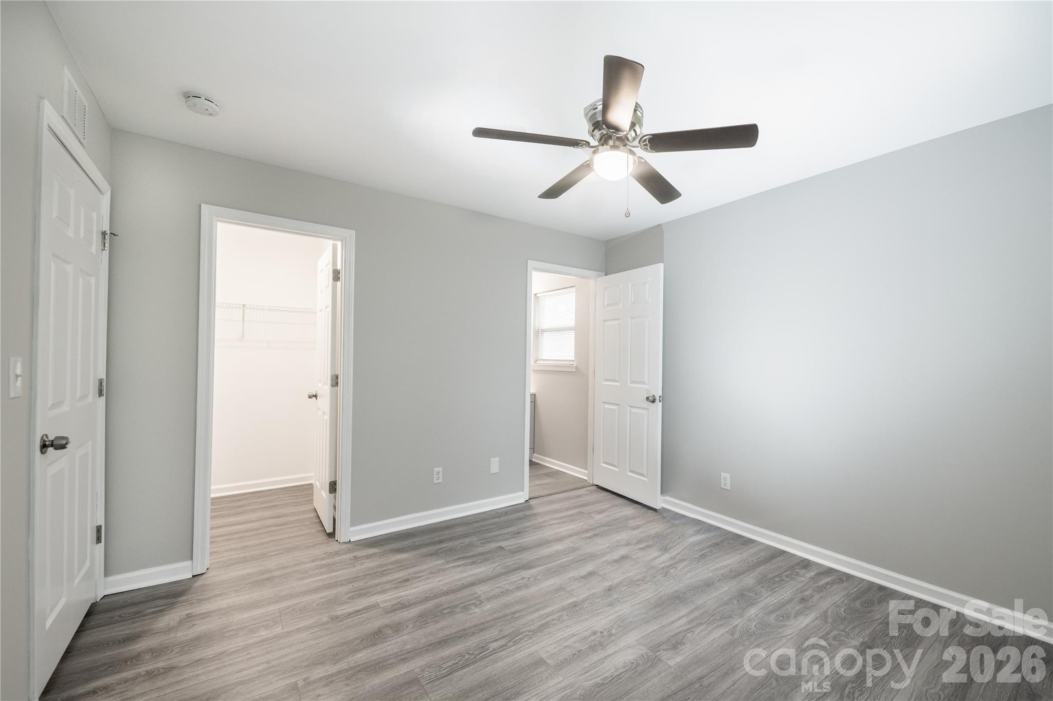 837 Rodey Avenue, Unit 20 Charlotte, NC 28206 - Photo 3 of 12 an empty room with wooden floor ceiling fan and windows