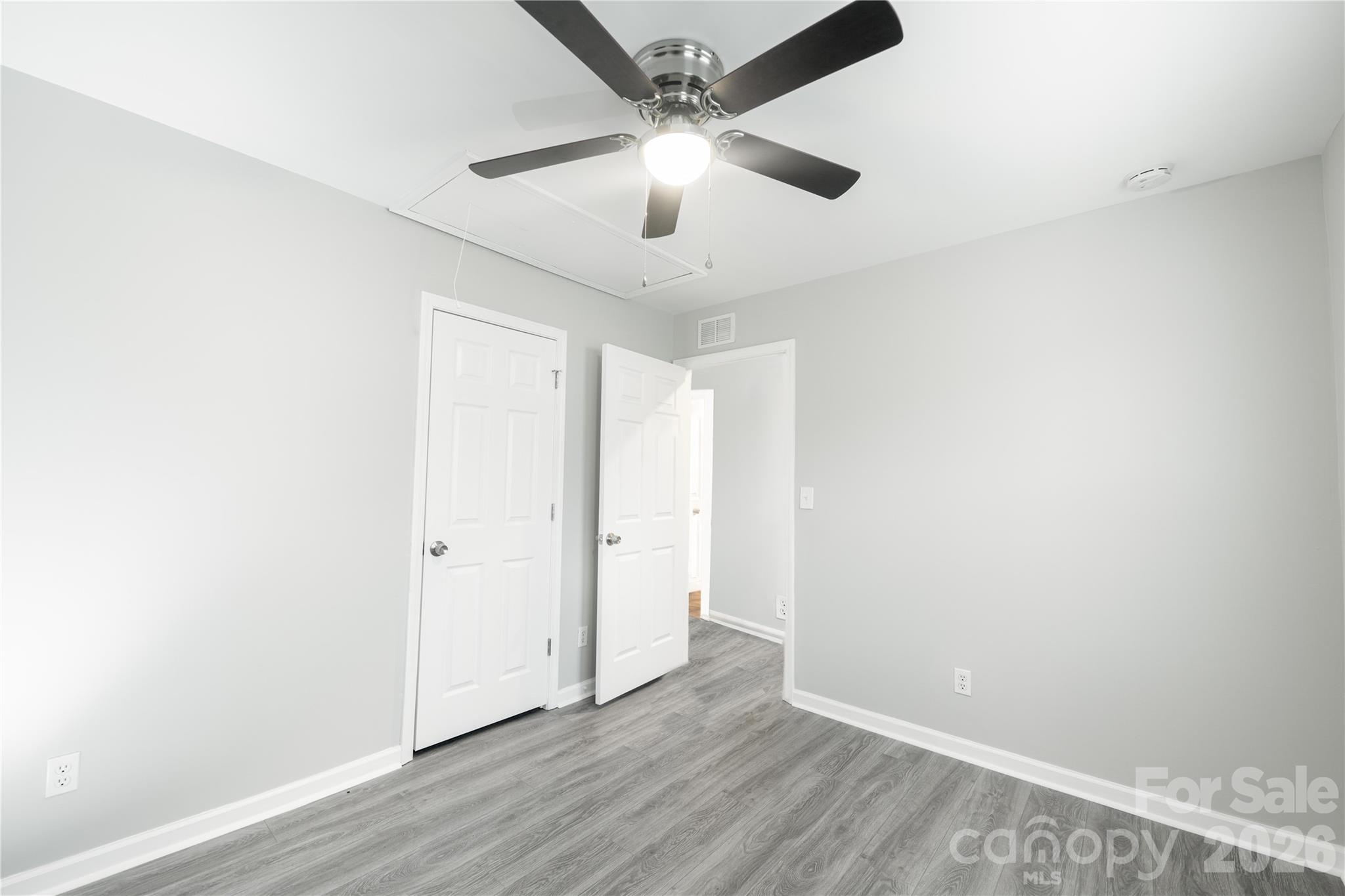 837 Rodey Avenue, Unit 20 Charlotte, NC 28206 - Photo 6 of 12 an empty room with wooden floor ceiling fan and window