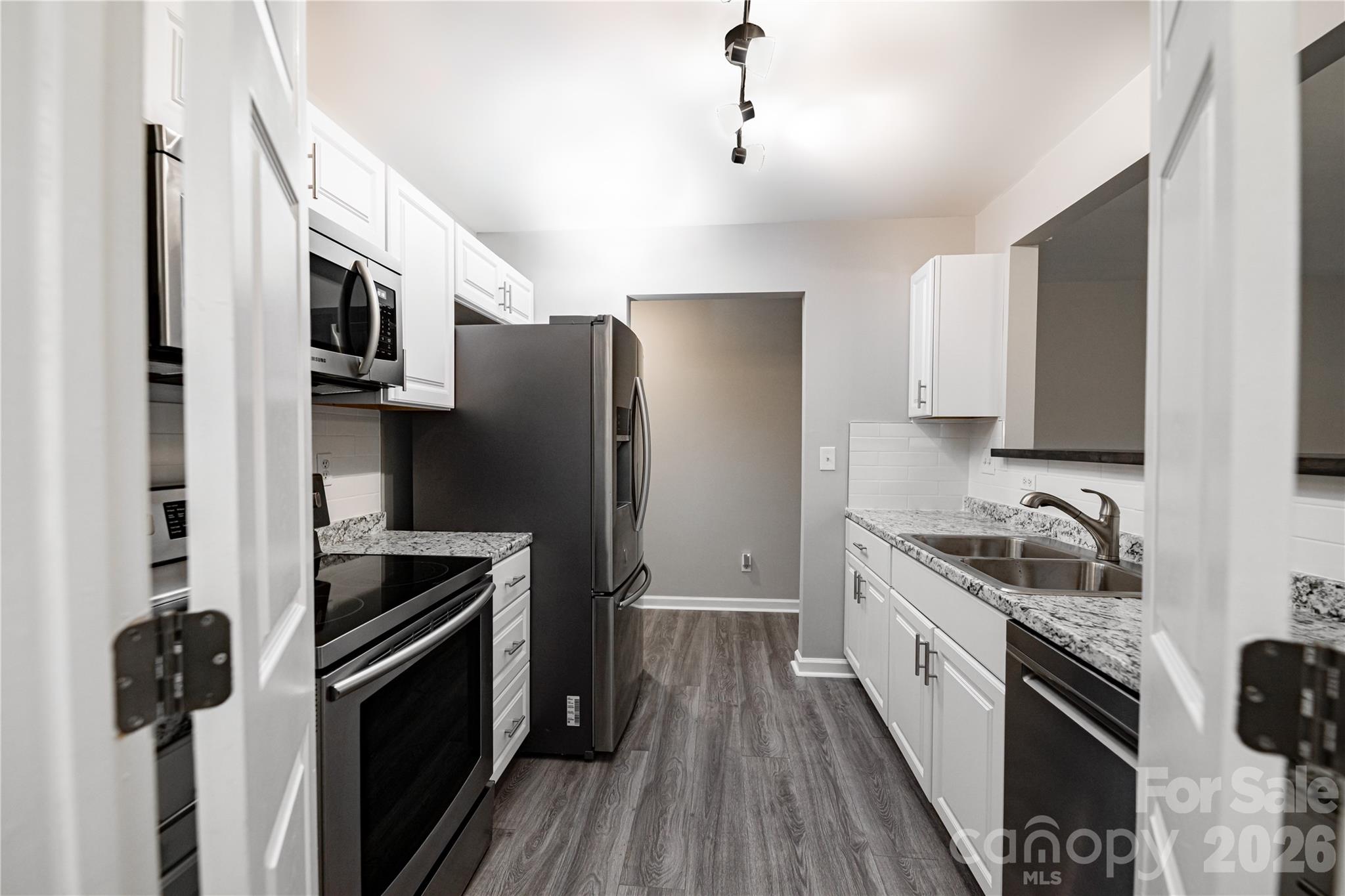 837 Rodey Avenue, Unit 20 Charlotte, NC 28206 - Photo 8 of 12 a kitchen with stainless steel appliances a sink stove and refrigerator