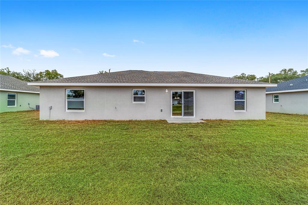 7866 North Manville Road Citrus Springs, FL 34434 - Photo 15 of 19 a backyard of a house with lots of green space