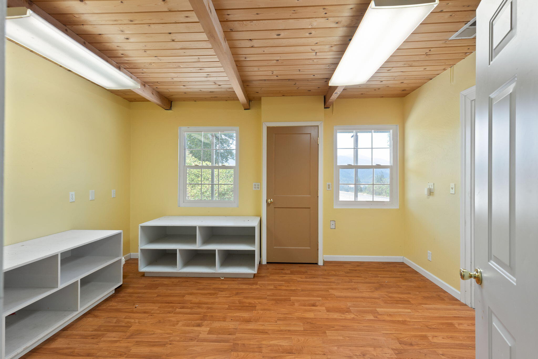 7304 North Applegate Road Grants Pass, OR 97527 - Photo 58 of 87 a view of empty room with wooden floor and windows