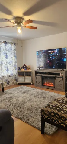 a room with water heater and a wooden floor
