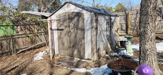a backyard of a house with table and chairs